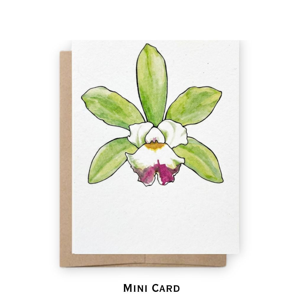 A mini greeting card featuring a watercolor orchid illustration with green leaves, a white center, and a magenta-pink lower petal, shown with a brown kraft envelope on a white background. The text 'MINI CARD' is printed below.