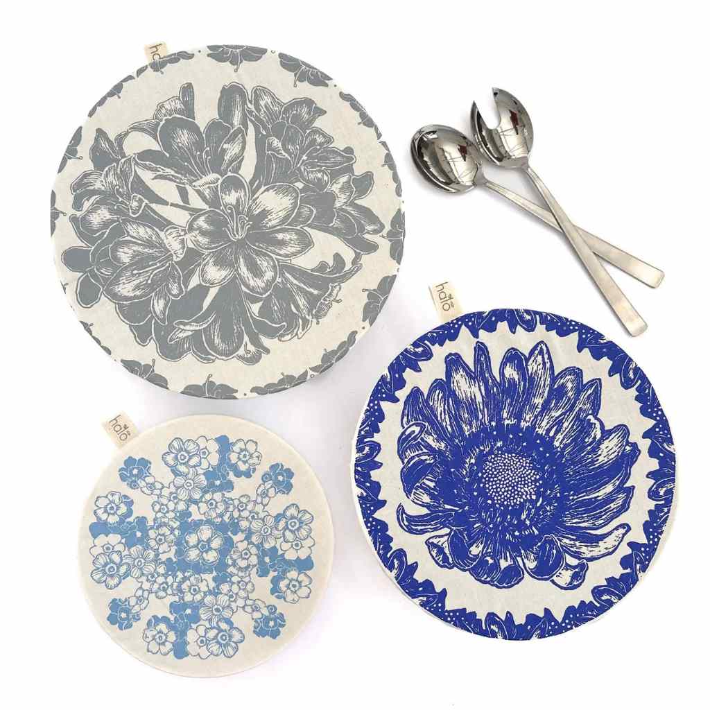 Set of three decorative dishcovers with floral designs on a white background