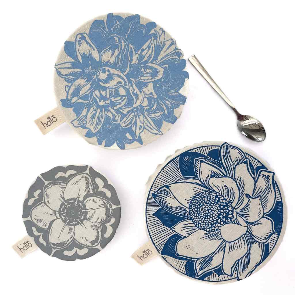 Three floral dish covers with a spoon on a white background