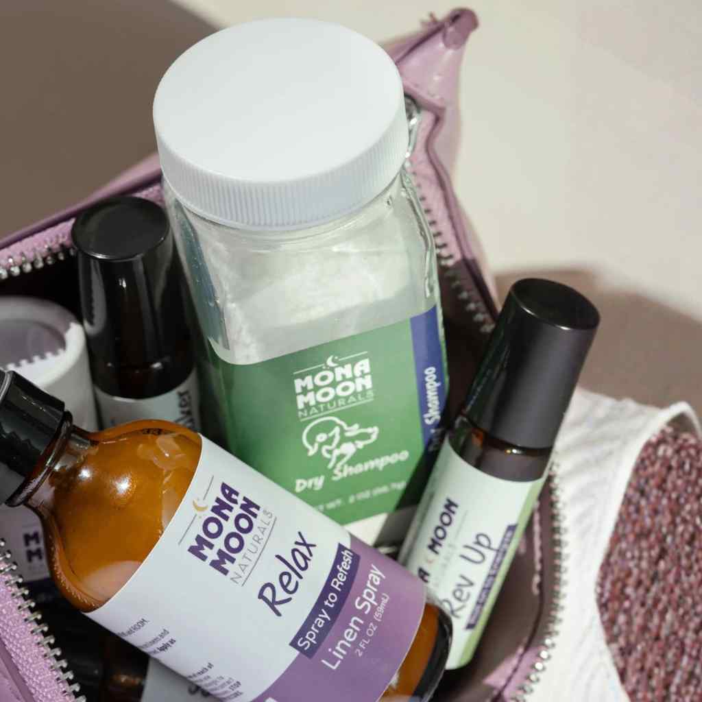 Collection of Mona Moon Naturals products including dry shampoo, linen spray, and other personal care items.