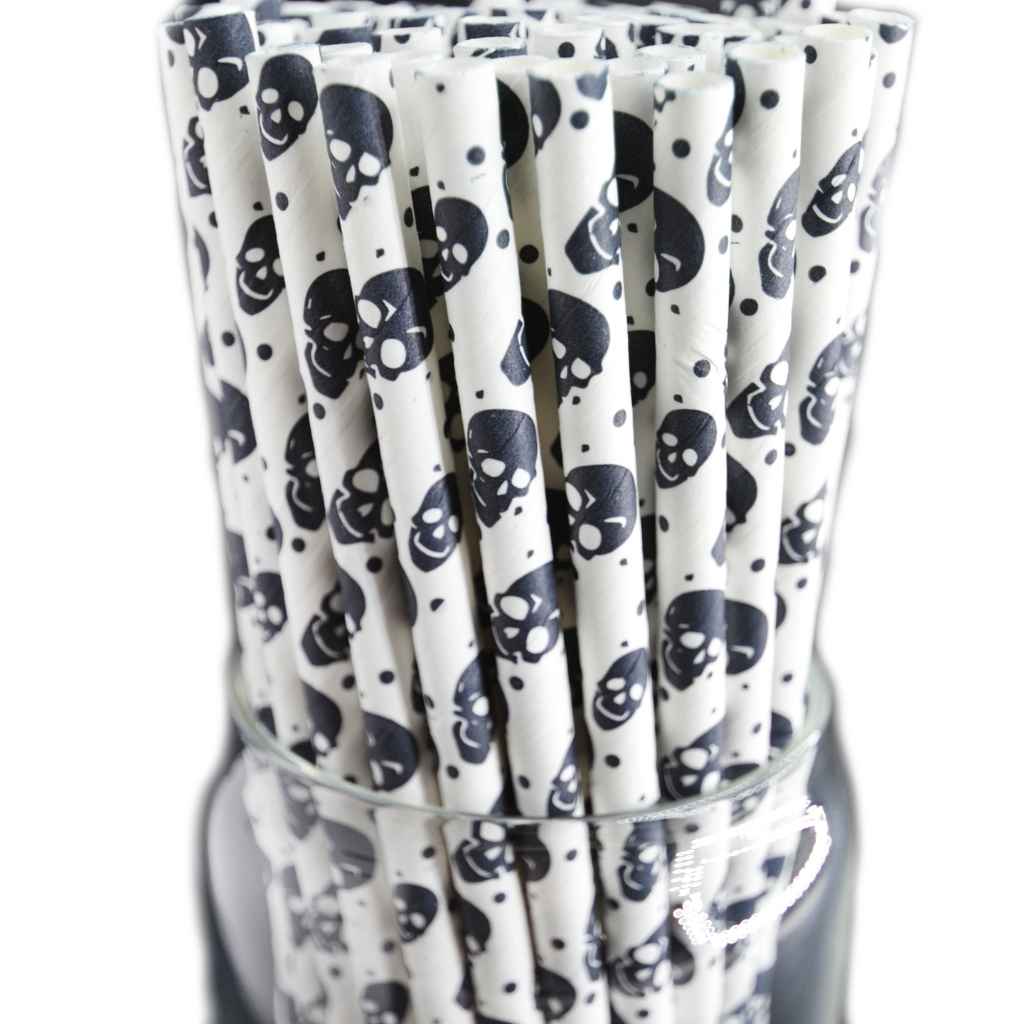 white straws printed with black skulls in clear container on white background.