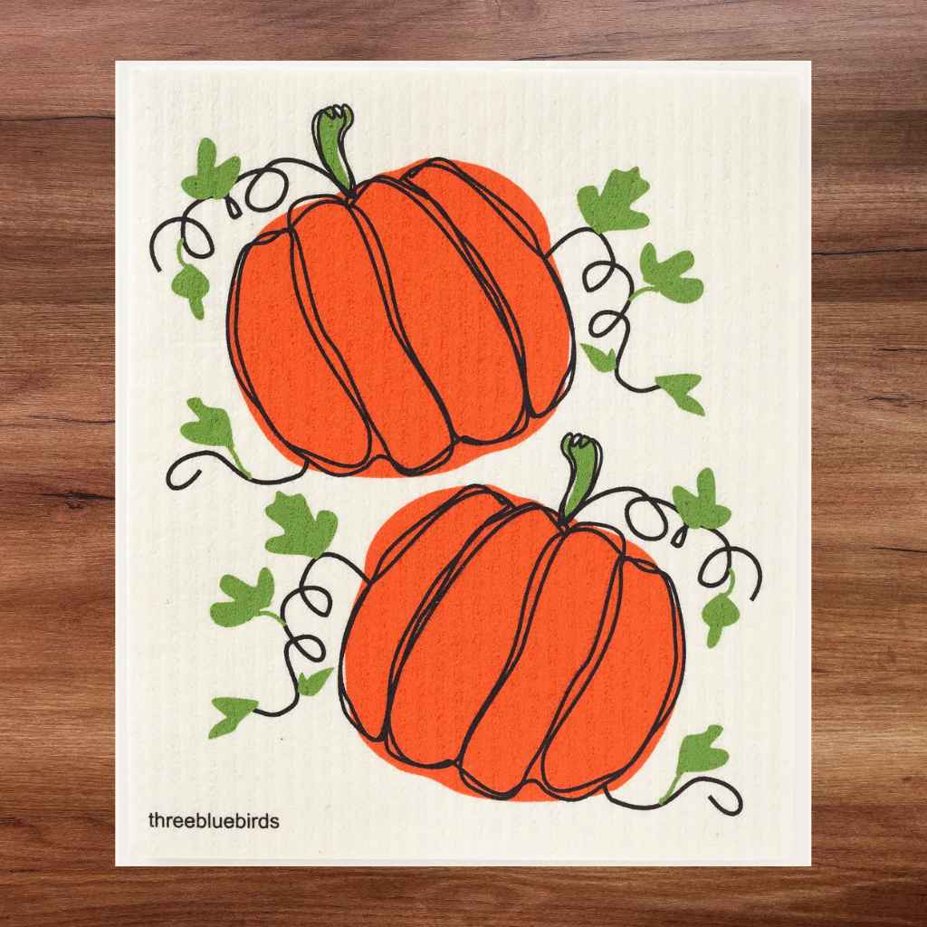White swedish dishcloth with two bright orange pumpkins