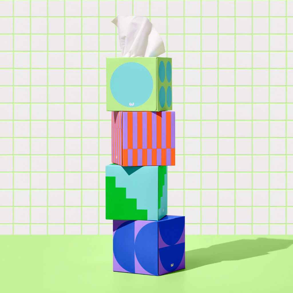 a stack of 4 multicolored boxes of forest-friendly bamboo facial tissues