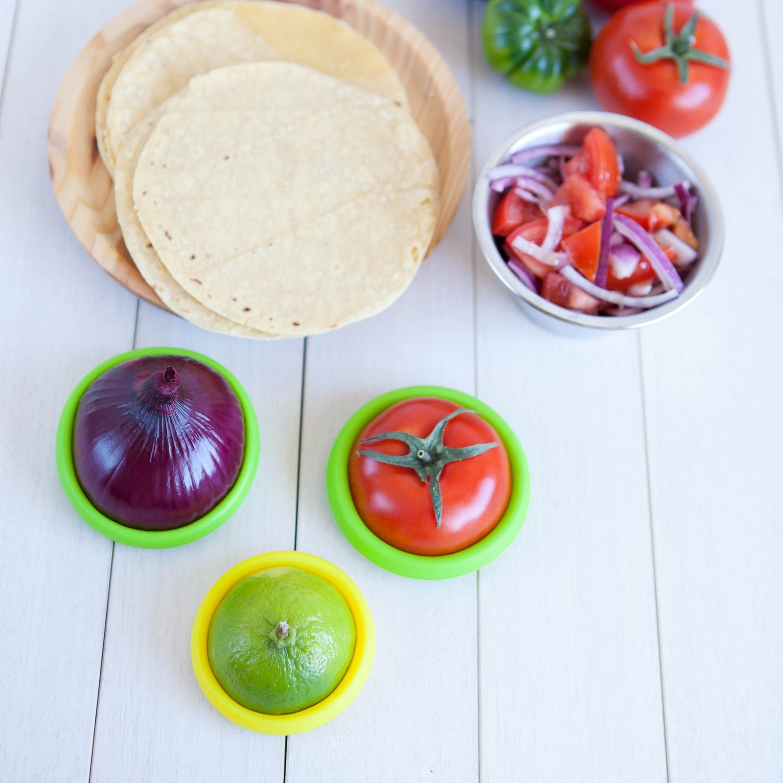 tortillas, pico de gallo next to  lime, onion, tomatos using food huggers