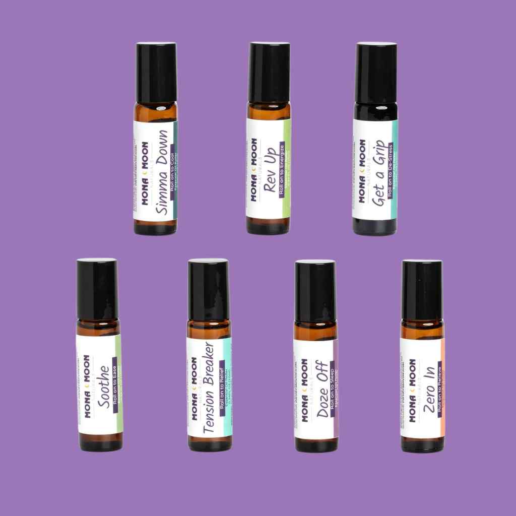 Set of roller bottles with labels on a purple background