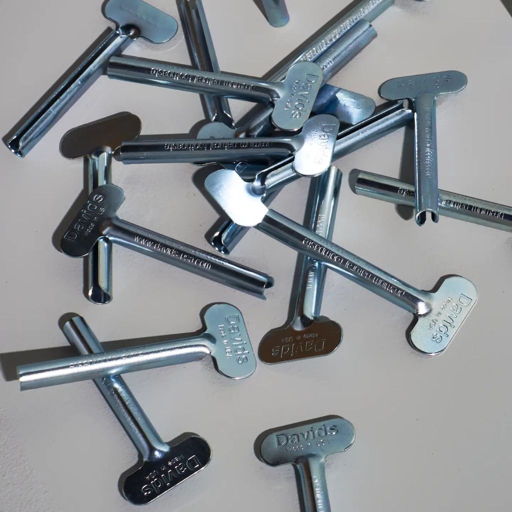 Collection of metal keys with 'David' branding on a light background