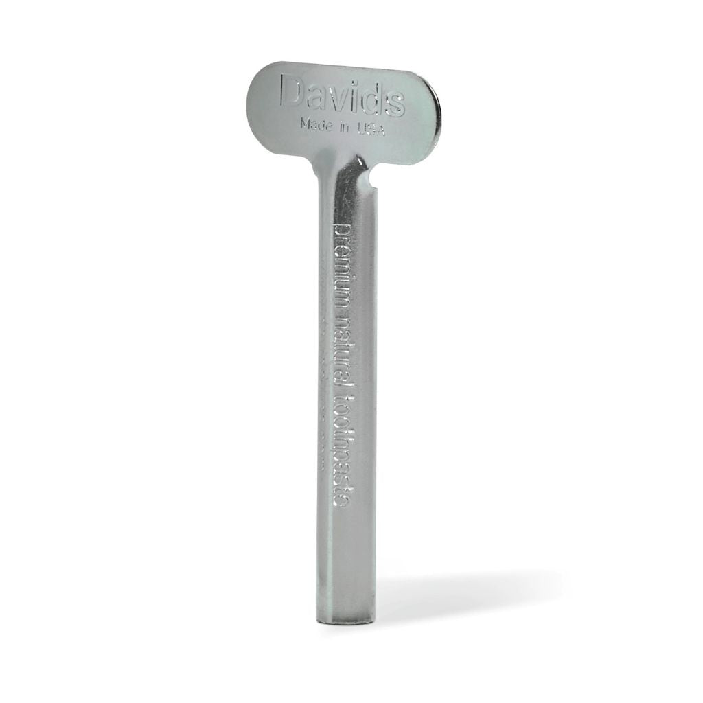 Metallic toothpaste tube tool with 'Davids' branding on a white background