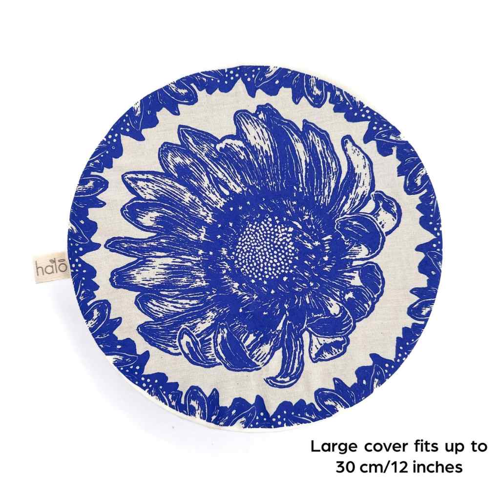 Round blue floral design dish cover with text on a white background