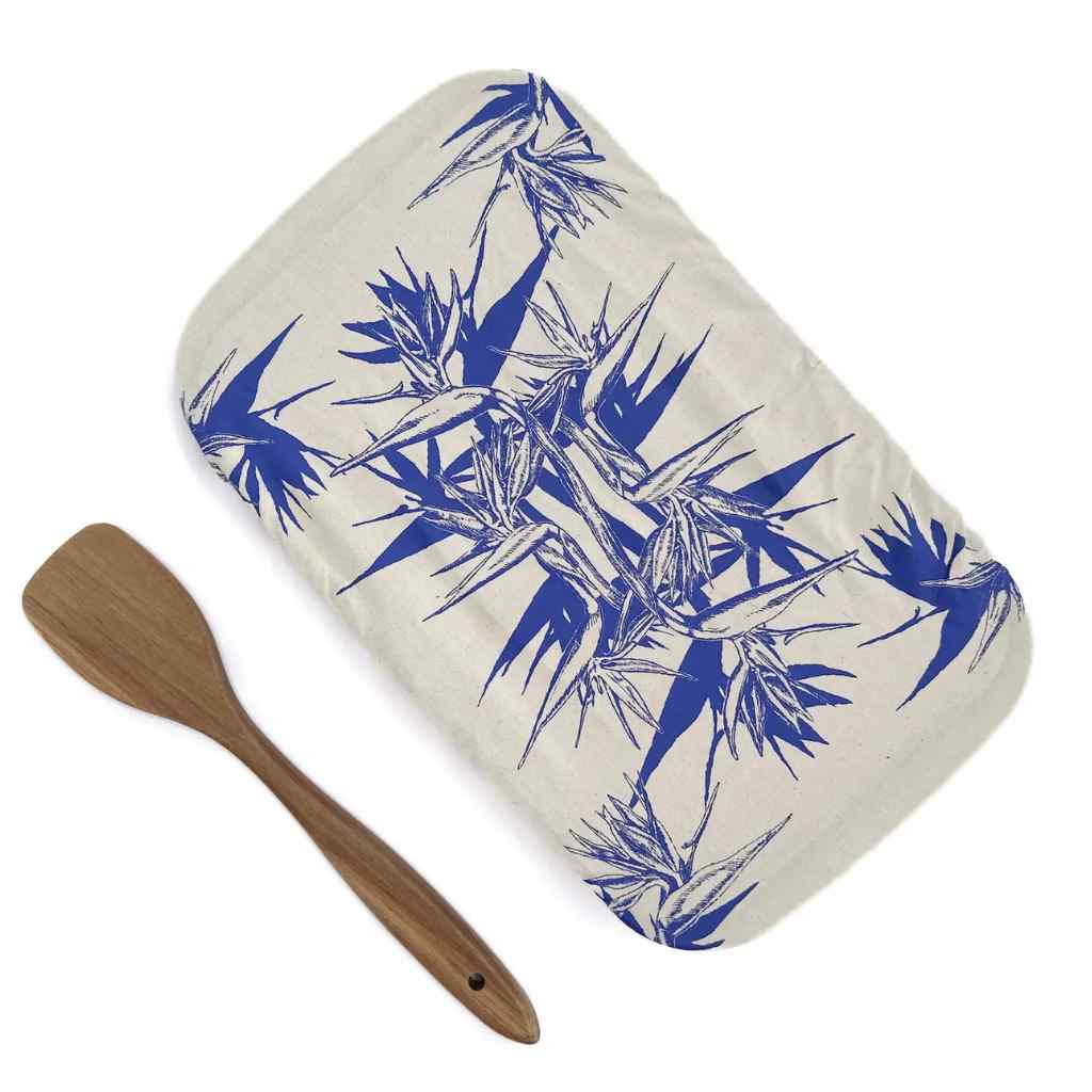 Rectangular dish cover with blue bamboo pattern and wooden spatula on a white background