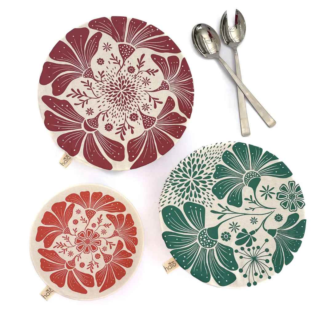 Three decorative bowl covers with floral patterns on a white background