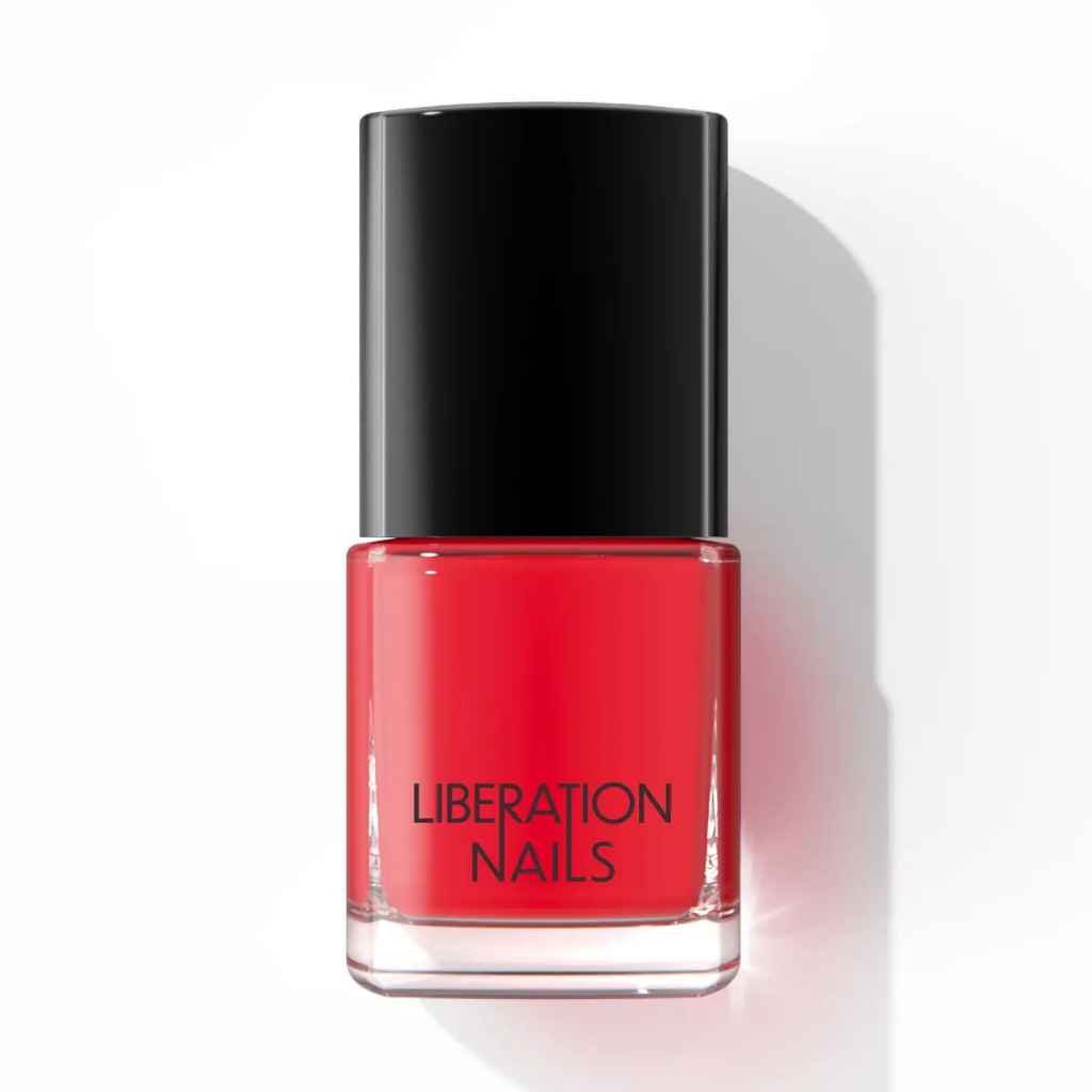 Red nail polish bottle with black cap on a white background