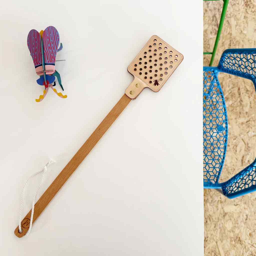 Fly swatter with a colorful fly figure on a white background