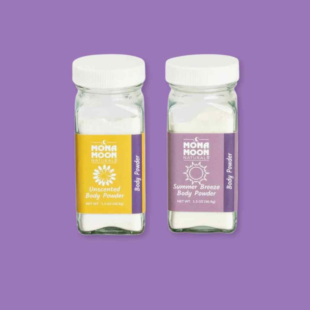 Two bottles of talc-free Mona Moon Naturals body powder on a purple background
