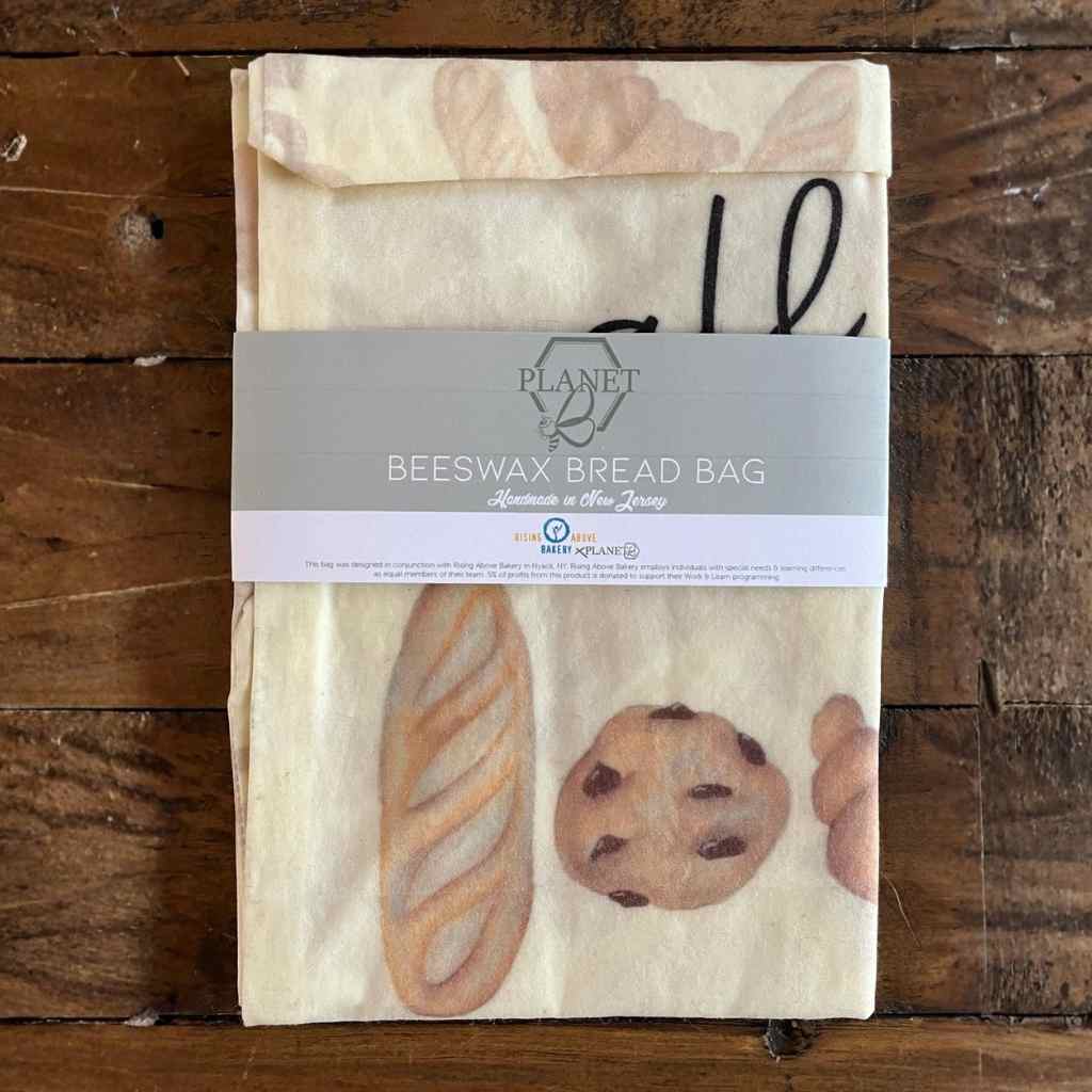 Beeswax bread bag with illustrations of bread and cookies on a wooden surface