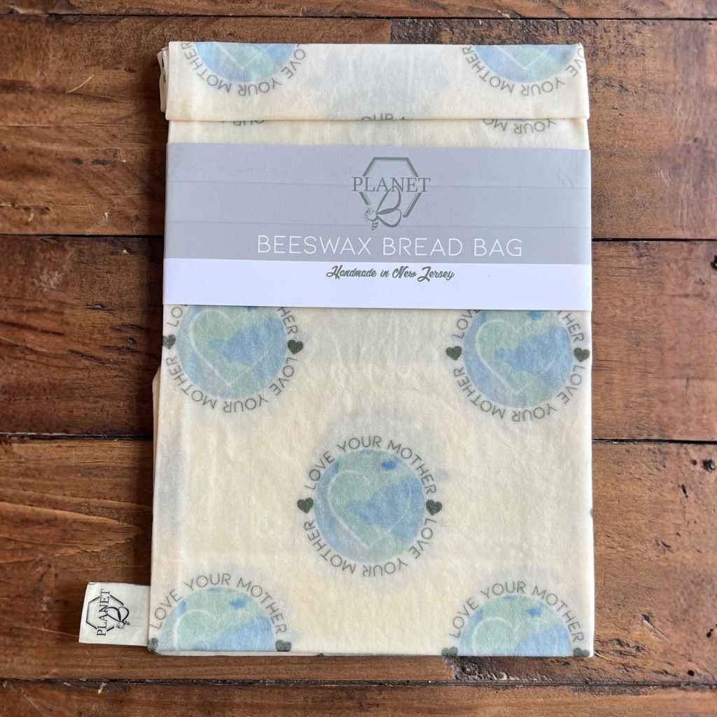 Beeswax bread bag with 'Planet B' branding on a wooden surface