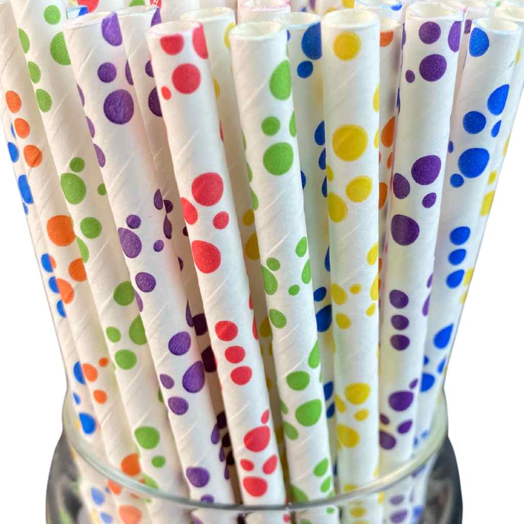 Colorful polka dot paper straws in a glass container