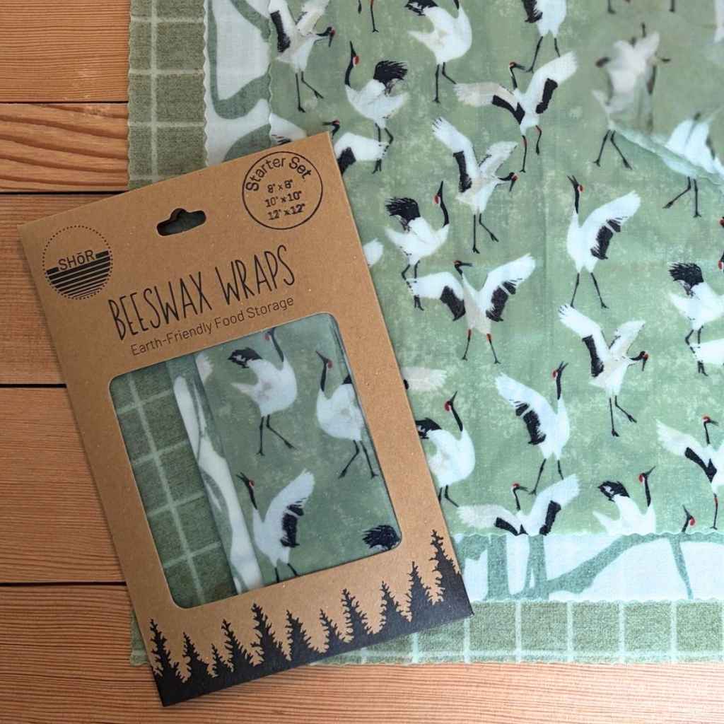 Beeswax wrap with bird pattern packaging on a wooden surface