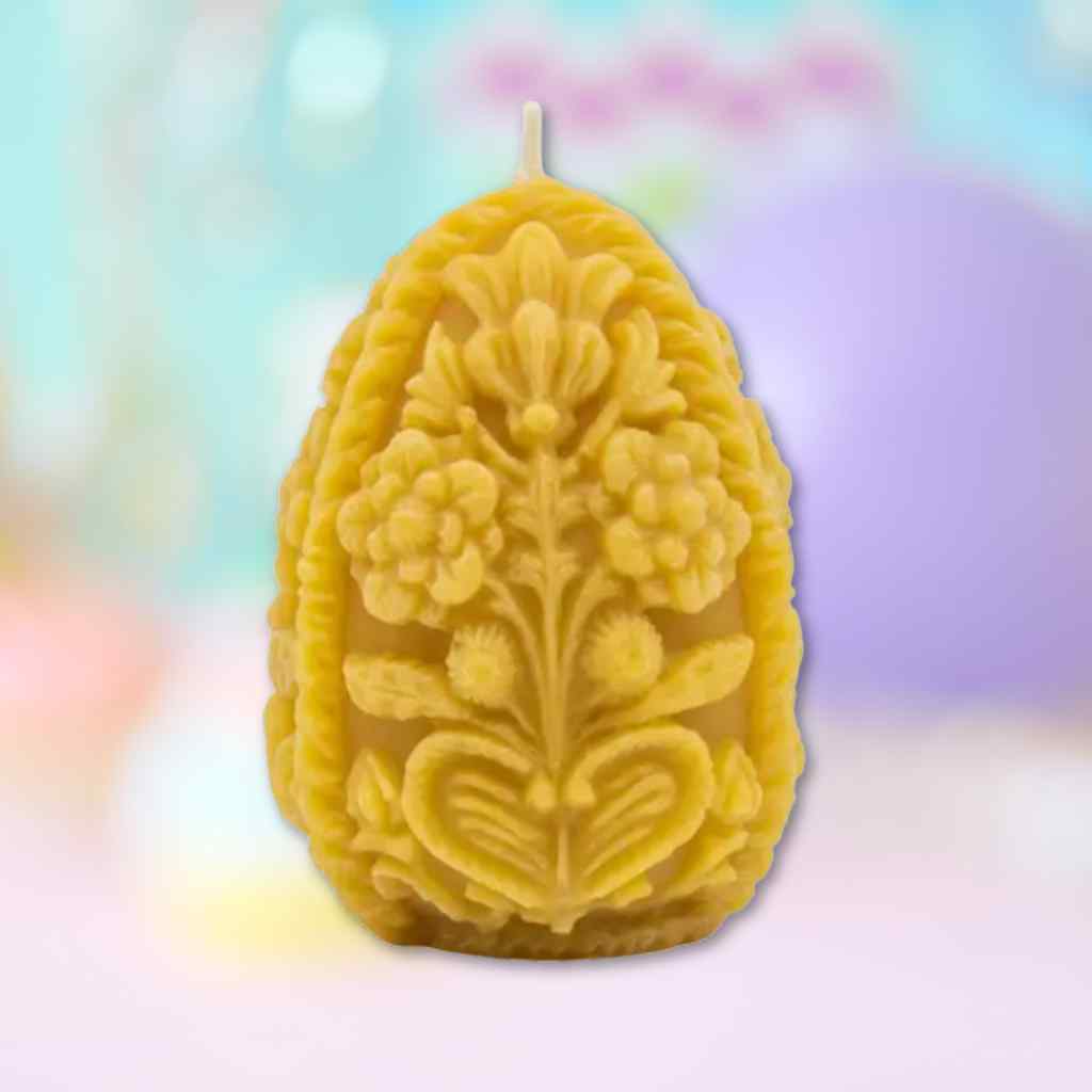 Decorative beeswax candle with floral design on a colorful background