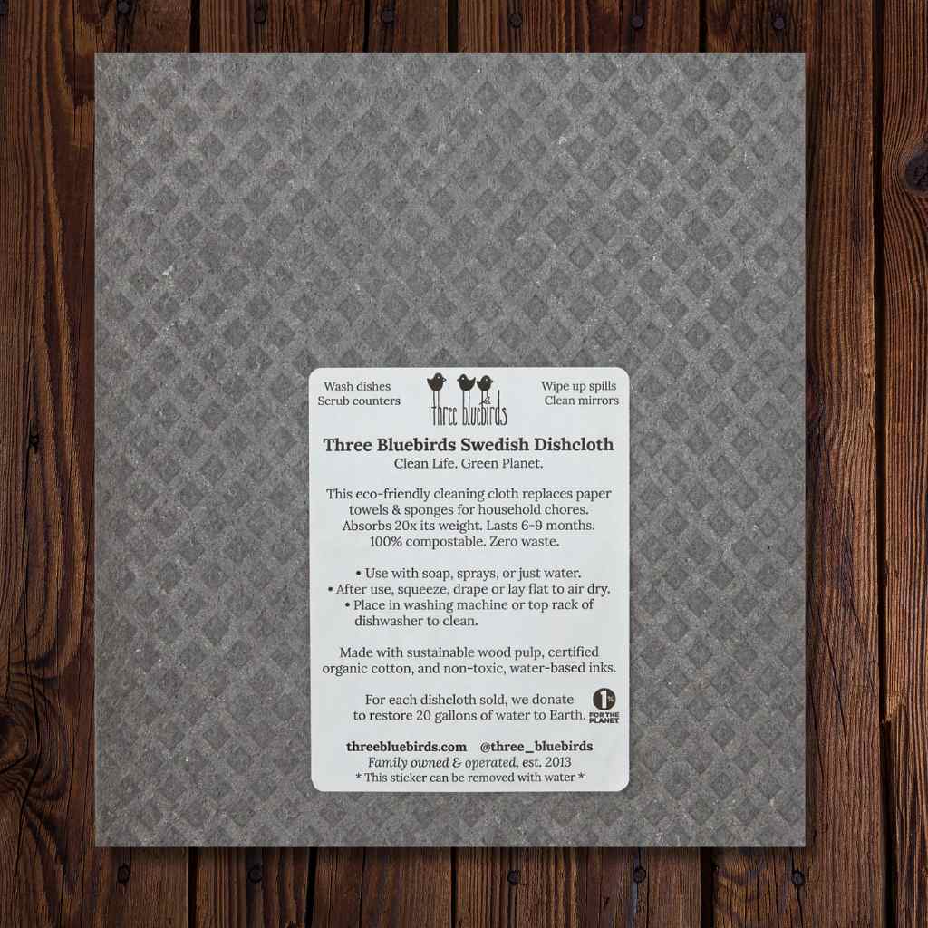 Gray cleaning cloth with product information label on a wooden surface