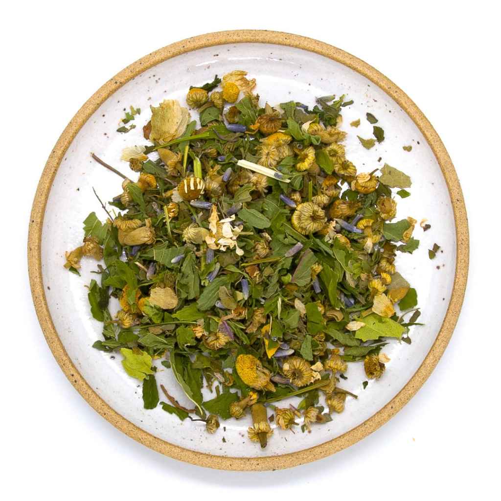 Herbal tea mix on a white plate with a beige rim