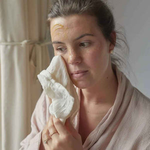 woman using UpCircle Cleansing Face Balm, vegan face cleanser for sensitive skin, award-winning all natural face balm.