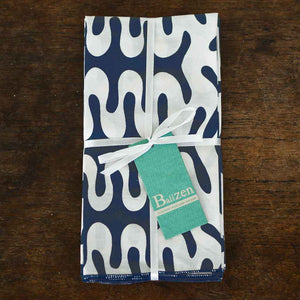 handmade cotton prima napkins with a light swirl design and a dark blue background made by Balizen