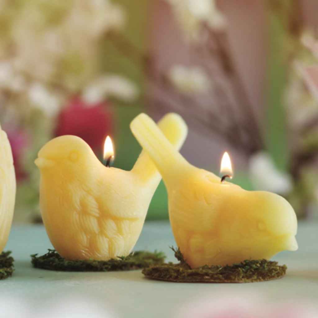 Sculpted Beeswax Candles in the shape of songbirds in two positions, upright and facing down (pecking). Made by Big Dipper Wax Works.