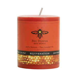 one medium pillar candle, orange in color with label. aromatherapy beeswax candle from Big Dipper Wax Works in Rejuvenation scent