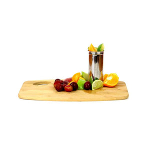 stainless steel flavor infuser strainer shown with cut pieces of fruit on a wooden cutting board