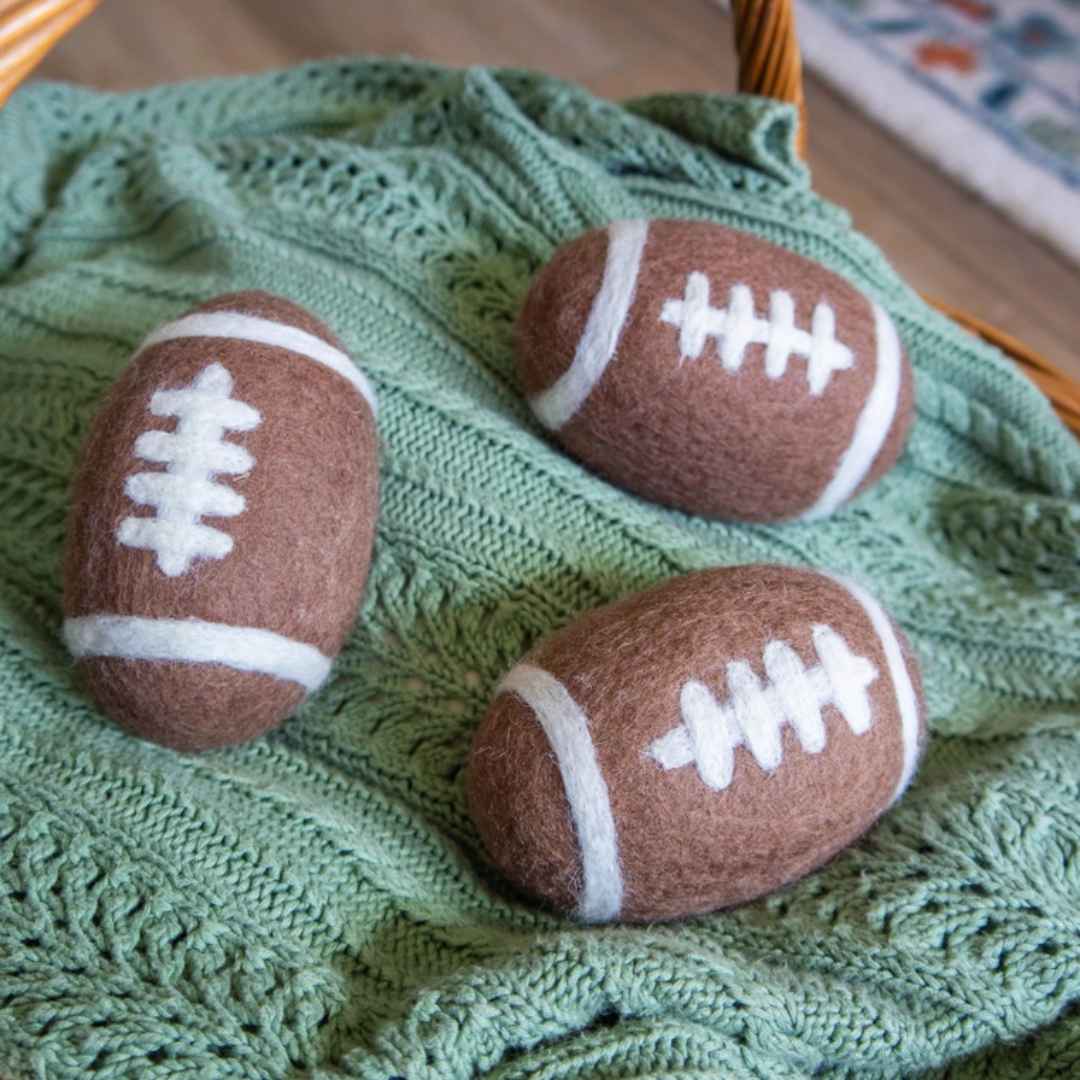 3 Friendsheep &quot;game day&quot; dryer balls (football shaped) on a green blanket