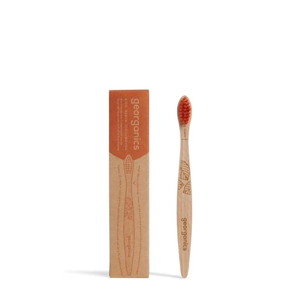 Georganics kids vegan toothbrush with orange nylon bristles.