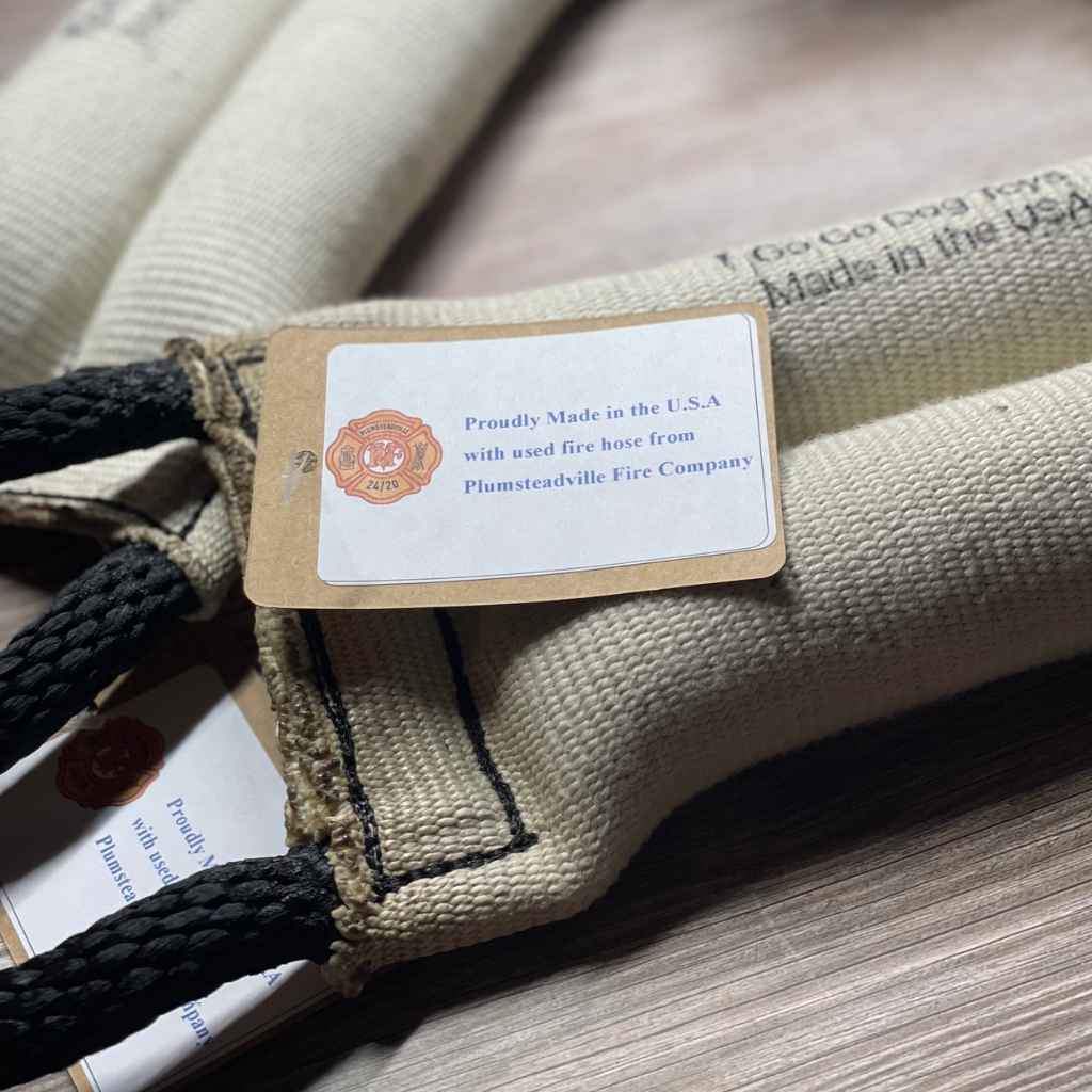 Recycled Fire Hose Tug Toy with Dual Rope Handles comes with tag to indicate from which fire company the materials originated