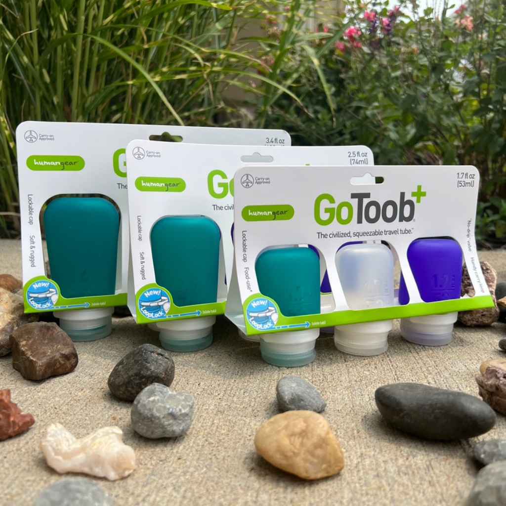 Refillable Silicone Squeeze Bottles for Travel made by humangear - GoToob+ is TSA approved for air travel. Designed in USA. 3-pack includes purple, clear, and teal silicone bottles.