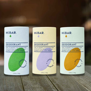 Three bars of natural, plastic-free HiBar deodorant sitting on a table 