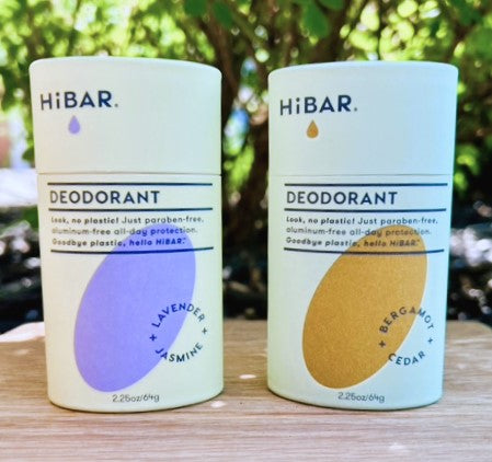 two bars of natural, plastic-free HiBar deodorant sitting on a table outside