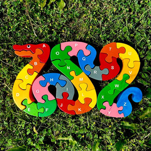 Mr. Ellie Pooh wooden puzzle, colorful snake shape with alphabet letters on one side and numbers on the back.