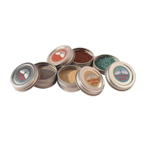 a pile of open tin containers with various glitters inside. Eco-Friendly Glitter made by Natural Earth Paint