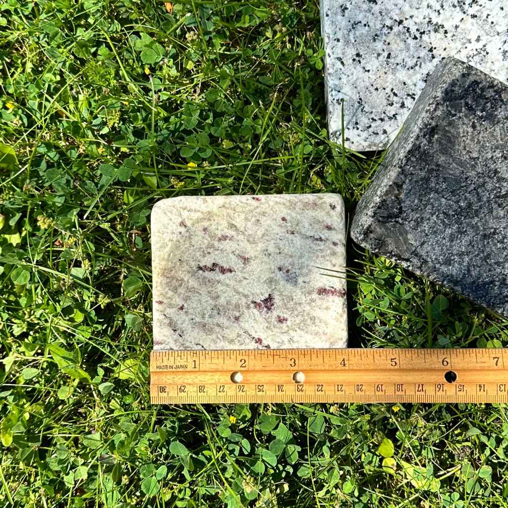 Cove Soap Dish made of reclaimed hand-cut granite, sustainably sourced. Made by Sea Stones in USA. With ruler to show size.