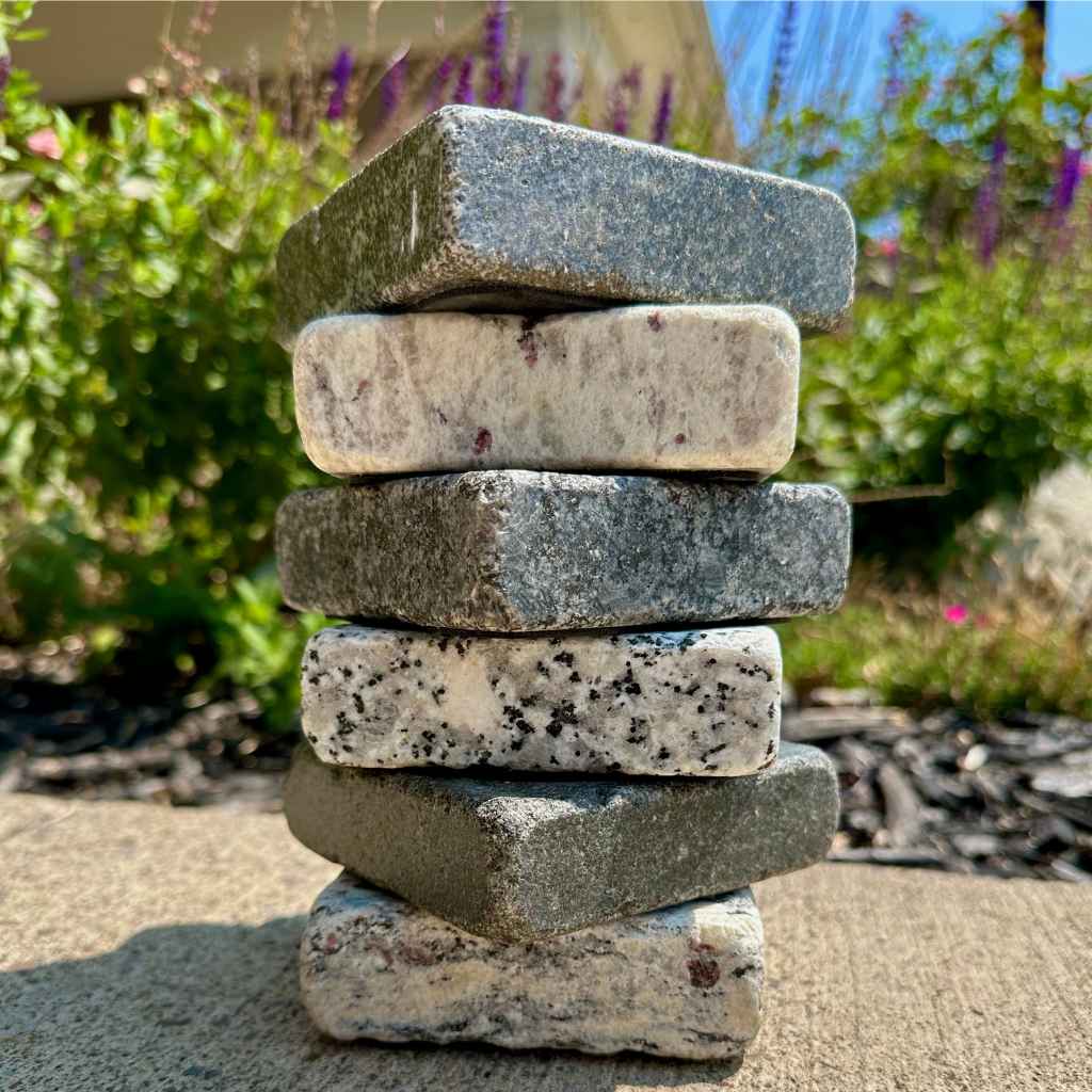 Stacked reclaimed granite soap dishes to show range of stone options.