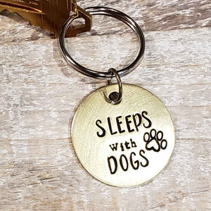 Upcycled Brass Keyring Pendant hand-stamped with the message "Sleeps with Dogs" made by The Junk Girls
