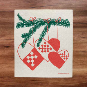 Swedish dishcloth with evergreen spring and read and white patterned heart ornaments hanging (design)