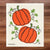 White swedish dishcloth with two bright orange pumpkins