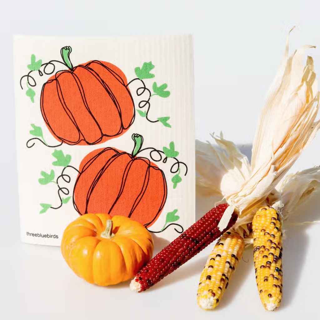 White swedish dishcloth with two bright orange pumpkins