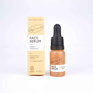 small glass bottle with dropper top, shown with paperboard box. UpCircle organic Face Serum