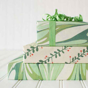 Eco Wrapping Paper made from recycled and compostable newspaper - holiday print with green marbling and springs of holly. Made in USA by Wrappily