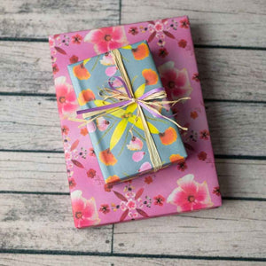 Eco Wrapping Paper by Wrappily - Pink Hibiscus reversible & recyclable gift wrap. Pink with flower petals blue with yellow and orange petals. Made in USA.