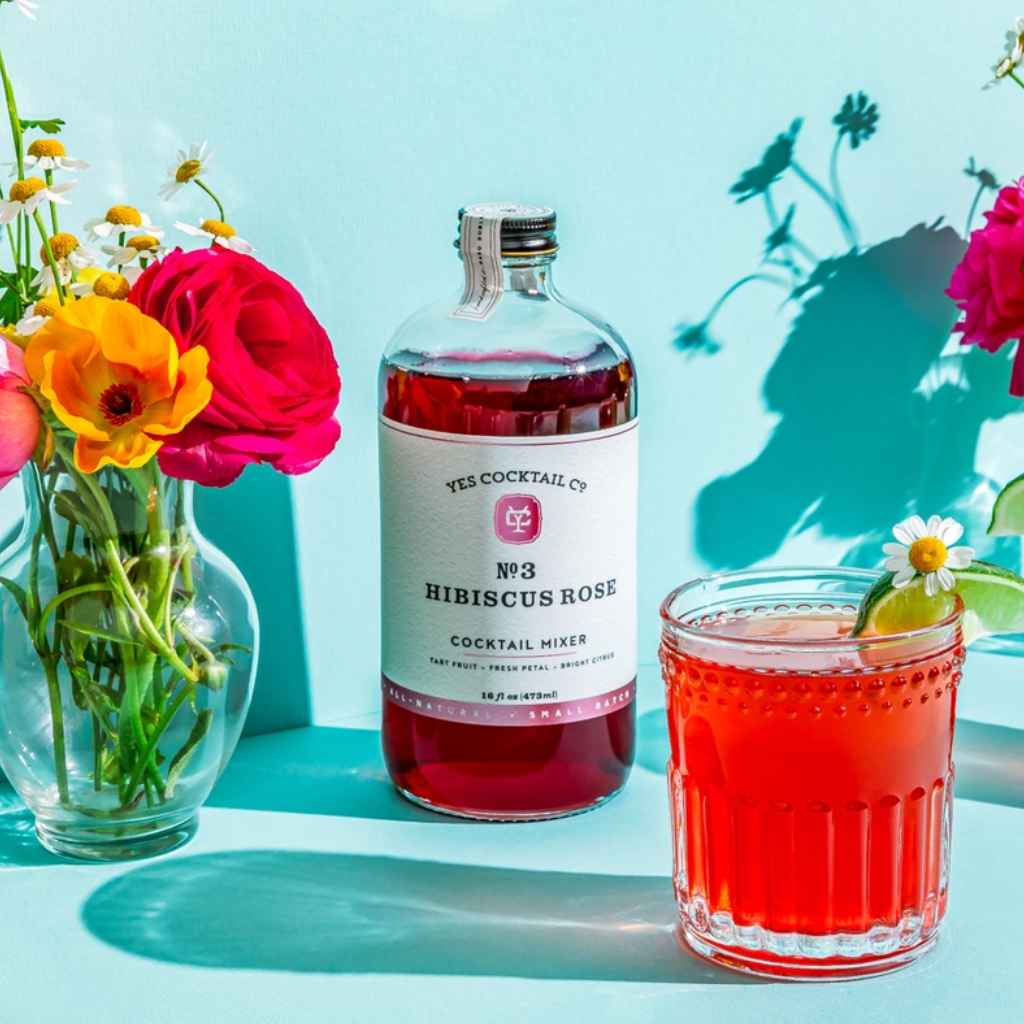 Glass bottle of Hibiscus Rose Cocktail Mixer by Yes Cocktail Co. all natural, small batch, handcrafted.