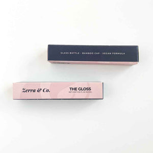 paper box packaging for Zerra & Co. lip gloss, glass bottle, bamboo cap, vegan formula