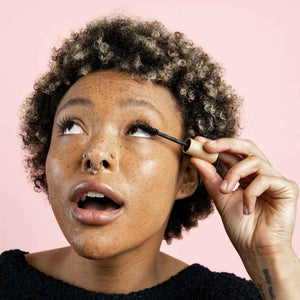 woman applying The Mascara by Zerra & Co. | Black
