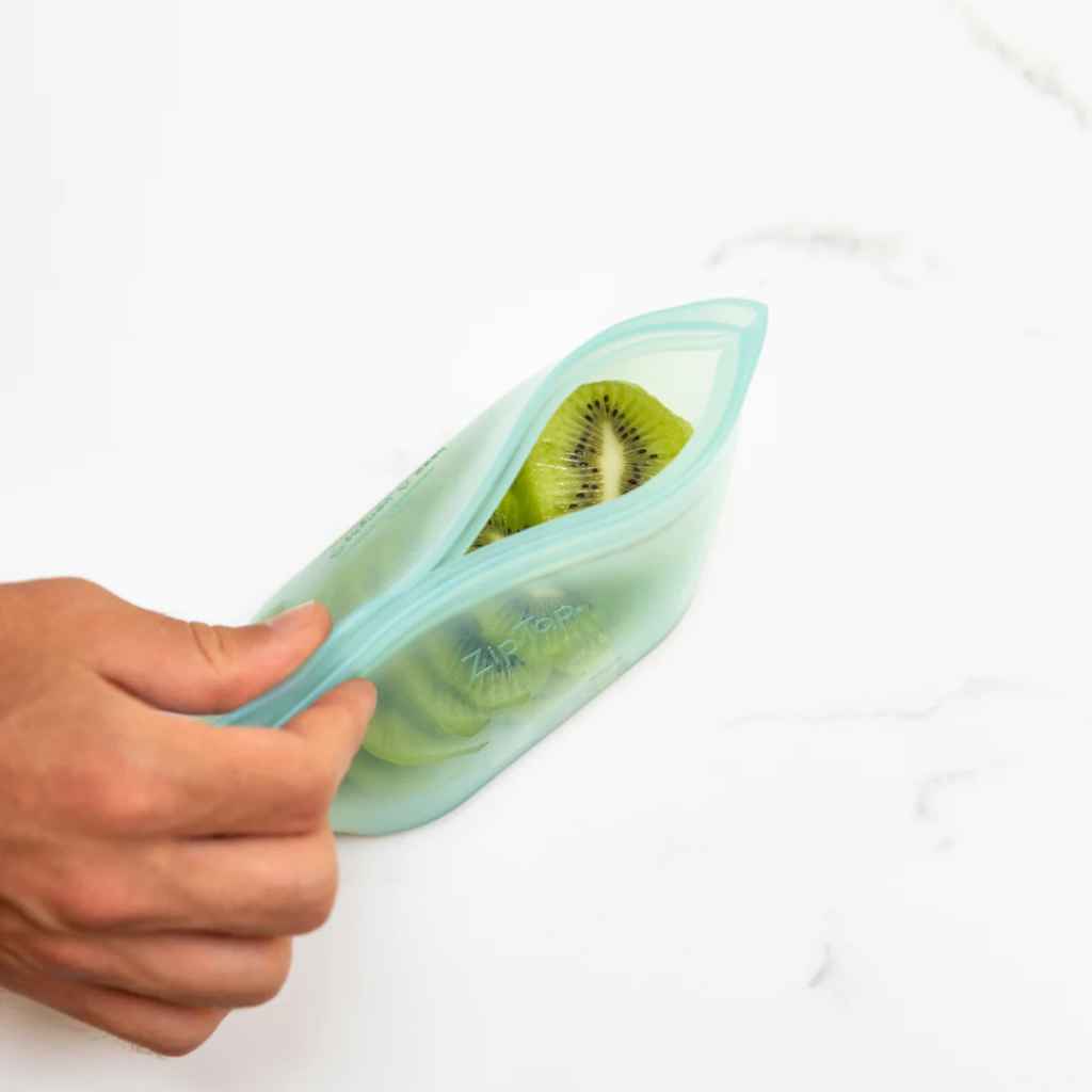 Zip Top 100% Platinum Silicone Reusable Food Storage Dishes, shown in small size with kiwis inside, in Teal color.